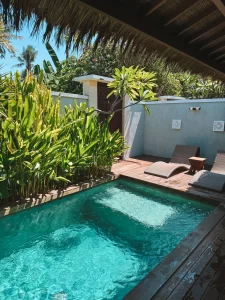 Tropical private pool with lounge chairs