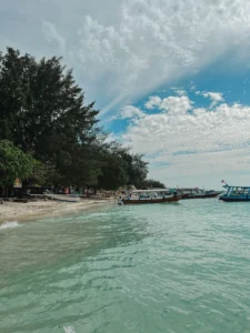 Gili Trawangan beach with traditional boats and turquoise water along the shoreline