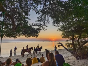 Sunset view with horses riding on Gili Trawangan beach