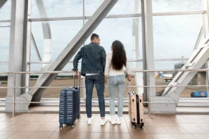 Couple at the airport with luggage preparing for a trip from Australia to Lombok and Gili Trawangan.
