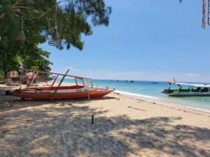 A modern fast boat docked at the clear water harbor of Gili Trawangan island.